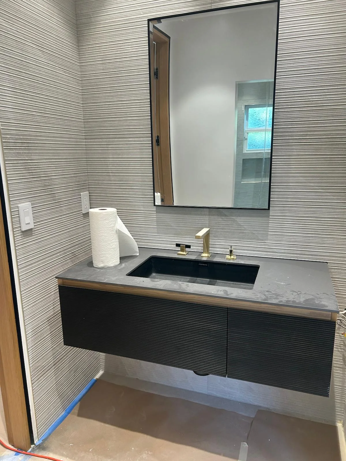 Modern bathroom vanity and mirror cleaned after a remodel